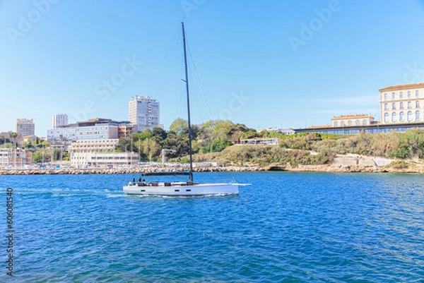 Fototapeta A scenic view of a sailboat leaving the port of Marseille, bouches-du-rhône, France under a majestic blue sky
