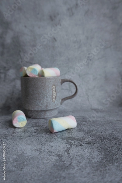 Fototapeta On a beautiful background, a mug with marshmallows. View from above.