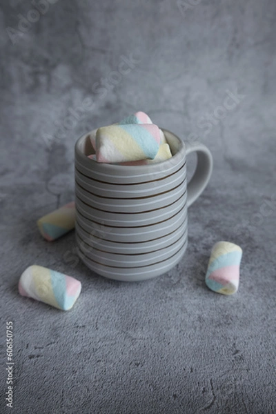 Fototapeta On a beautiful background, a mug with marshmallows. View from above.