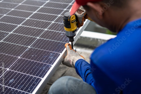 Fototapeta Technician installing solar panels on rails