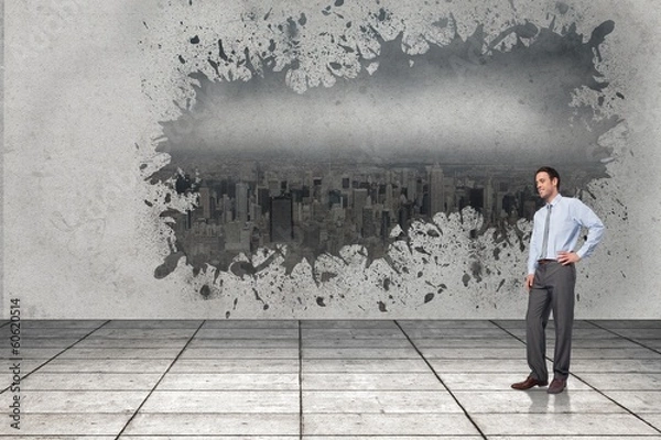 Fototapeta Composite image of smiling businessman with hand on hip