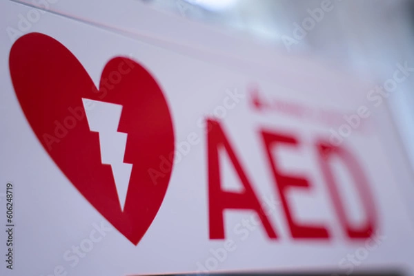 Fototapeta An automated external defibrillator (AED) in a white box is an emergency defibrillator for people in cardiac arrest. blurry concept