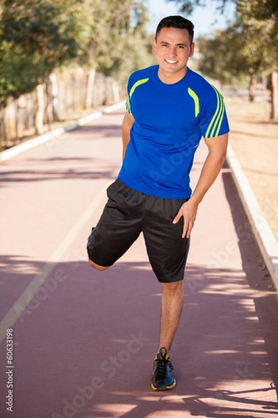 Fototapeta Stretching in a running track