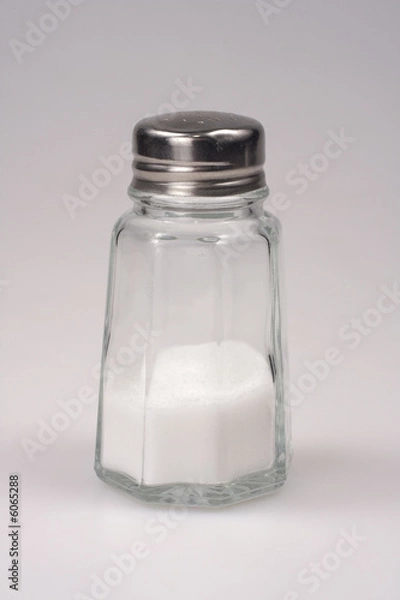 Fototapeta Close-up shot of a salt shaker on white background.