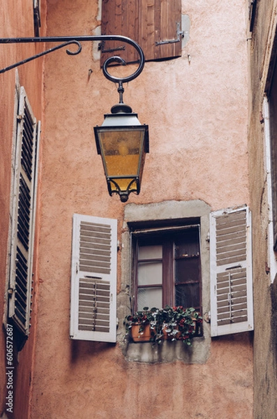 Obraz Window and flower in an alley with lamppost