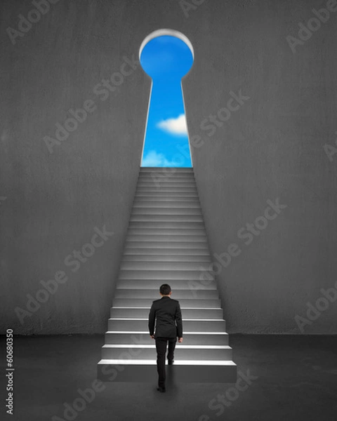 Fototapeta Businessman climbing on stair to key shape door with blue sky