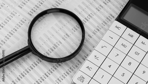 Fototapeta Calculator and magnifying glass on financial statement. Financial, accounting and business concept.