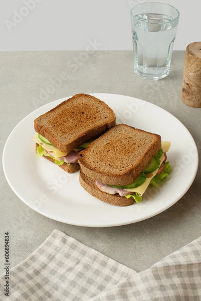Fototapeta sandwich with meat, cheese and vegetables on a gray background