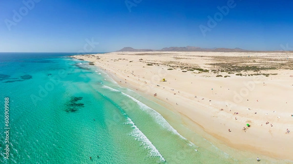 Fototapeta Beautiful mid level aspect aerial panoramic view of Grandes Playa beach with clear turquoise water near Corralejo in Fuerteventura Spain
