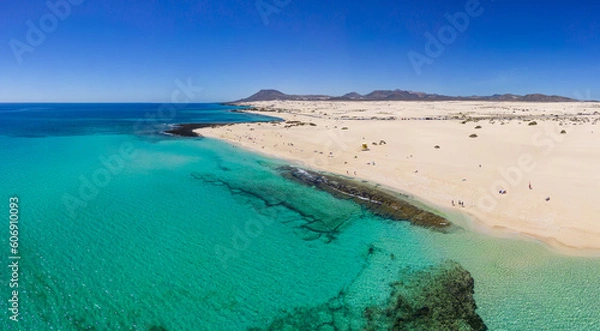 Fototapeta Beautiful high aspect aerial panoramic view of the white sandy beach of Playa del Dormidero near Corralejo in Fuerteventura Canary Islands Spain