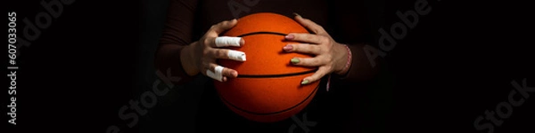 Fototapeta Banner 4x1 Concept Women's sport. Hands hold the ball. One hand in tapes. Second hand with manicure