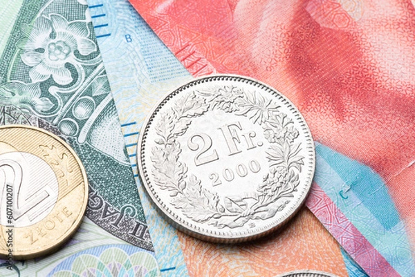 Obraz polish zloty currency and swiss francs currency coins and banknotes