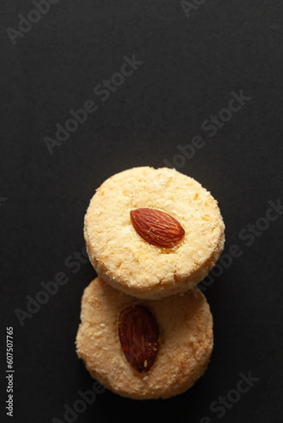 Obraz Two Almond Cookies on black background. Top-down view. Food Flat lay.