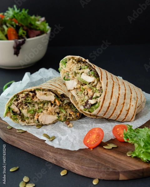 Fototapeta Chicken wrap with quinoa and pumpkin seeds. Healthy balanced food full with protein