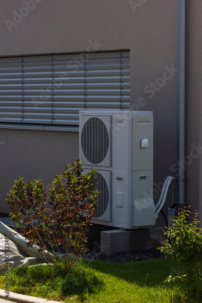 Obraz heat pump in a new building area with modern house facades
