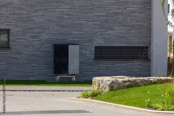 Fototapeta heat pump in a new building area with modern house facades
