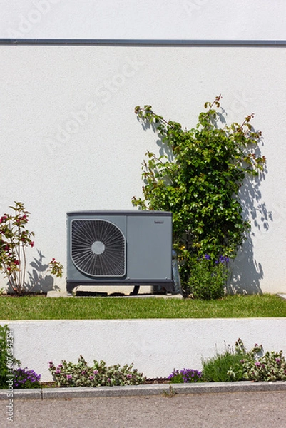 Obraz heat pump in a new building area with modern house facades