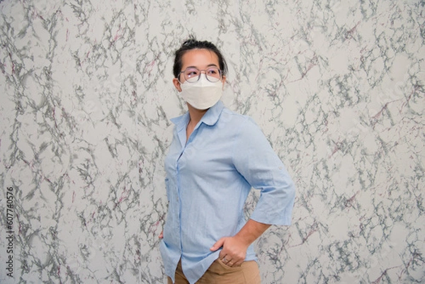 Obraz elegant womanman wearing a mouth protection to prevent getting sick at work or on the way to work  isolated on White background, pandemic and social distancing concept.Covid-19