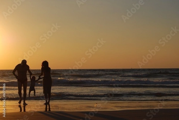 Obraz happy family on the sea beach at the moment of sunset
