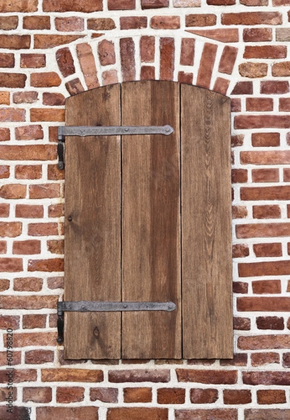 Fototapeta window shutter on an old brick wall