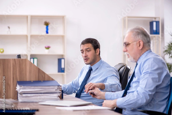 Fototapeta Two male colleagues working in the office