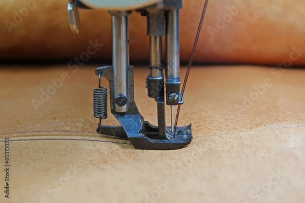 Fototapeta Closeup of sewing machine working part with leather