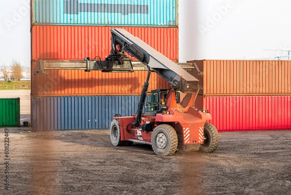 Fototapeta forklift truck with a heavy container imported in a ship from Asia 