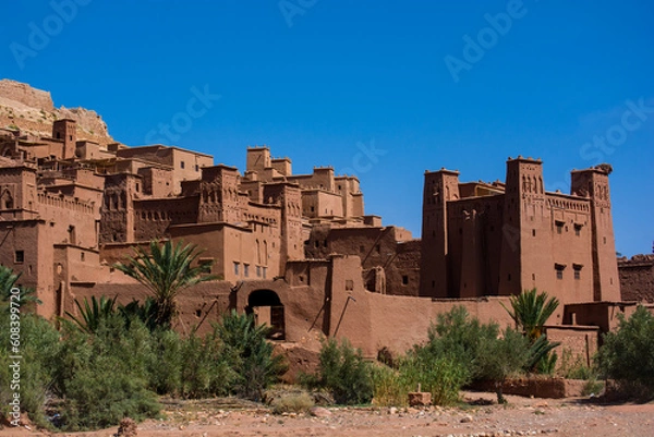 Fototapeta View to the old moroccan town. Wall and towers made from red clay