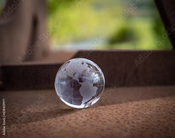 Fototapeta glass earth globe on the rusty iron table