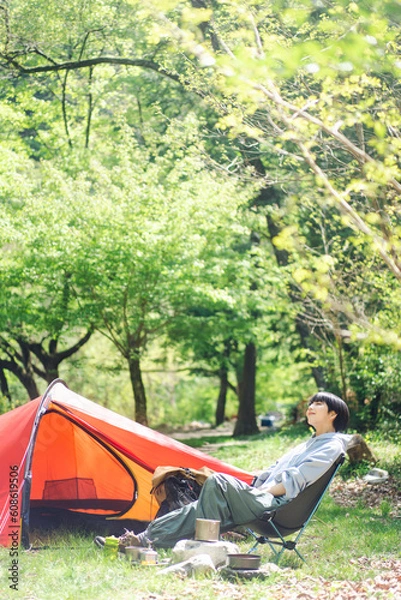 Fototapeta ソロキャンプをしている若い日本人女性/椅子に座りくつろいでいる