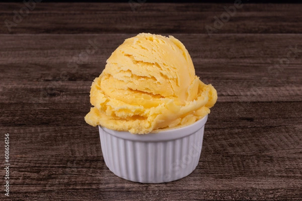 Obraz Delicious yellow ice cream served in a white pot. Tasty traditional yellow gelato enjoyed around the world.