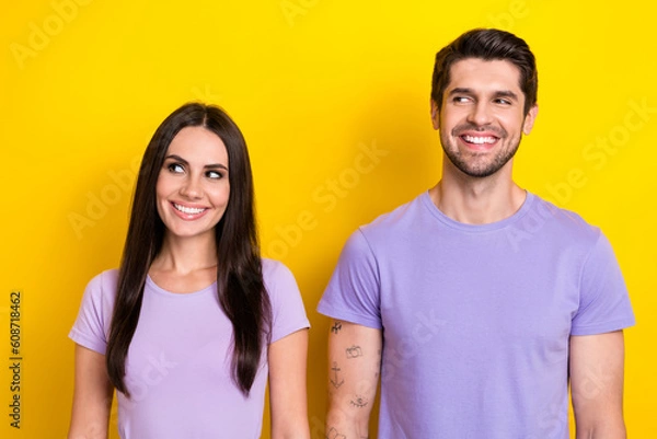 Fototapeta Portrait of two minded cheerful people toothy smile look empty space isolated on yellow color background