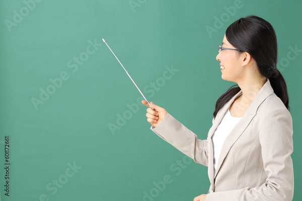 Fototapeta 指示棒で指す教師・女性