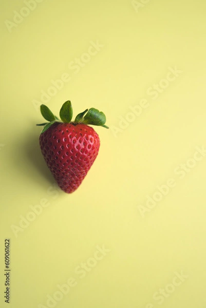 Obraz Ripe strawberries lie on a yellow background. View from above.