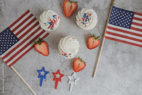 Obraz Cupcakes on the beautiful table. Healthy breakfast. Strawberry on cupcakes. American flag. Independence Day 4th of July.