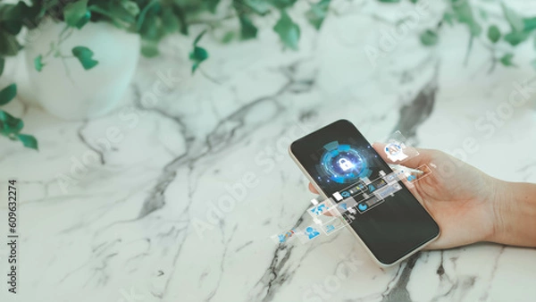 Obraz Business woman holding smart phone with network security icon. Protection network security computer and safe your data concept, cybersecurity and protection against dangers. Quality Assurance