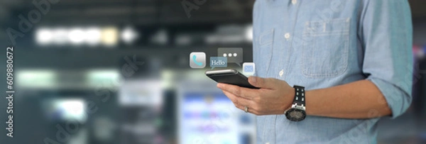 Fototapeta Man holding smartphone device  touching screen