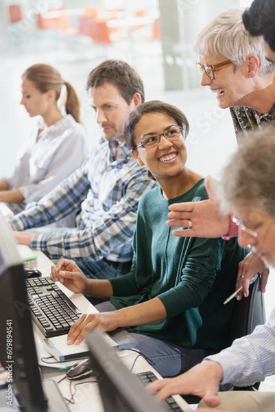 Obraz Students talking at computers in adult education classroom