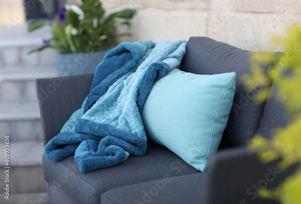Obraz Knitted Throw, gray sofa in the courtyard of the home garden

