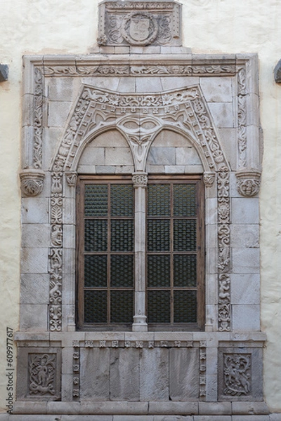 Fototapeta Detail of a very nice decorated old window, stone facade
