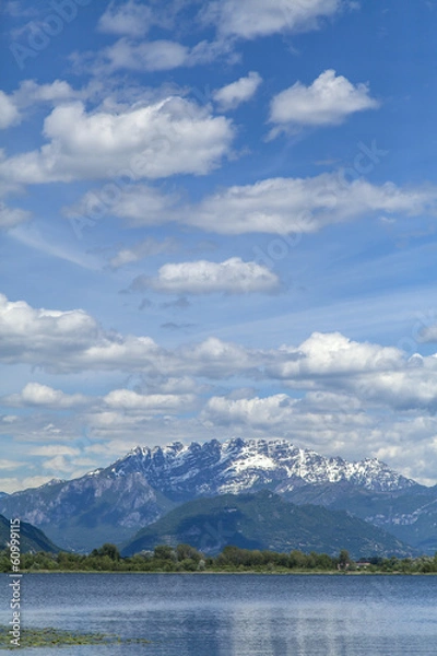 Fototapeta Spring clouds in the blue sky of Lake Alserio