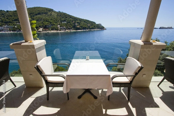 Fototapeta Table for two with sea view on restaurant terrace
