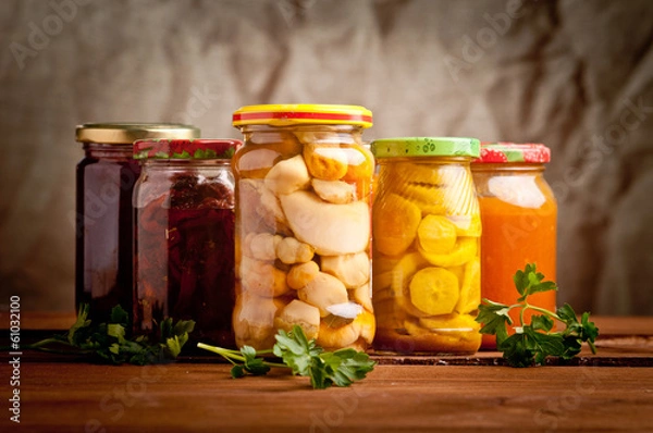 Obraz Composition with jars of pickled vegetables. Marinated food.