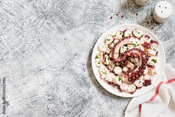 Obraz boiled chopped octopus on a concrete table