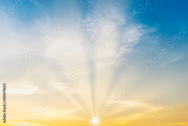 Obraz Sky blue and orange light of the sun through the clouds in the sky