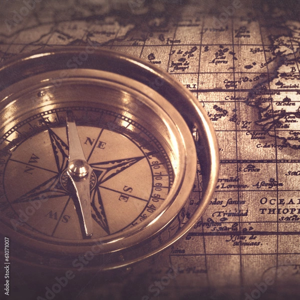 Fototapeta Old nautical compass over the map, abstract retro still life