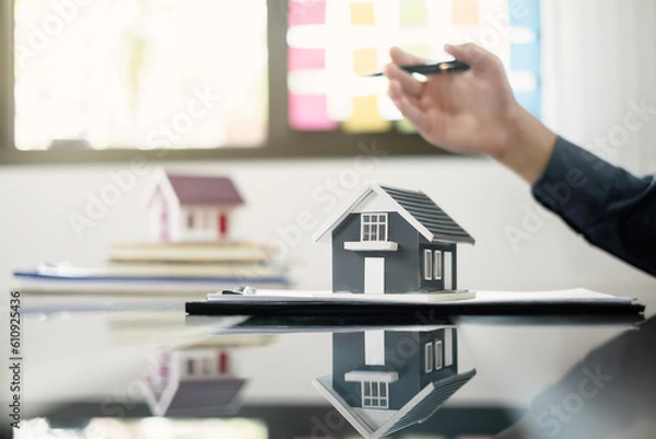Fototapeta Agents working in real estate investment and home insurance signing contracts in accordance with the home buying insurance agreements approving purchases for clients