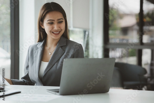 Fototapeta Working woman, Asian businesswoman working in the office, managing in the office, running a company, running a startup business. The concept of working in a startup company.