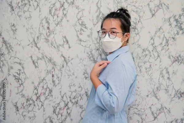 Obraz elegant womanman wearing a mouth protection to prevent getting sick at work or on the way to work  isolated on White background, pandemic and social distancing concept.Covid-19