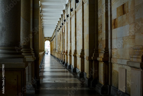 Fototapeta Long corridor between many columns in Mill Colonnade. Day shoot. It is a large colonnade containing several hot springs.